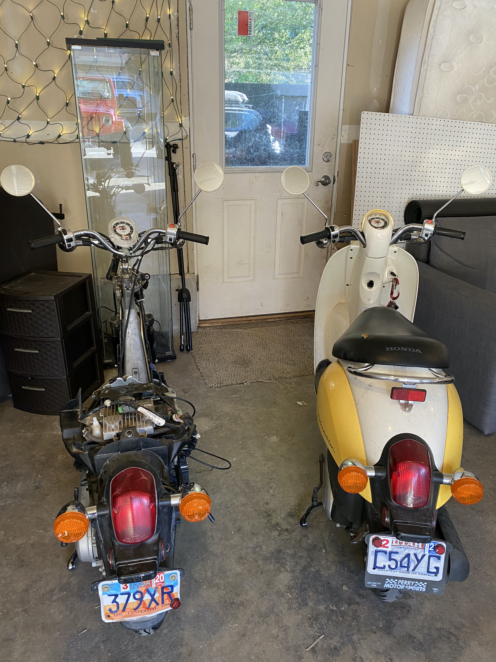 My pink Metropolitan on the left, with all the fairings removed. On the right is a fully put together Honda Metropolitan in Yellow